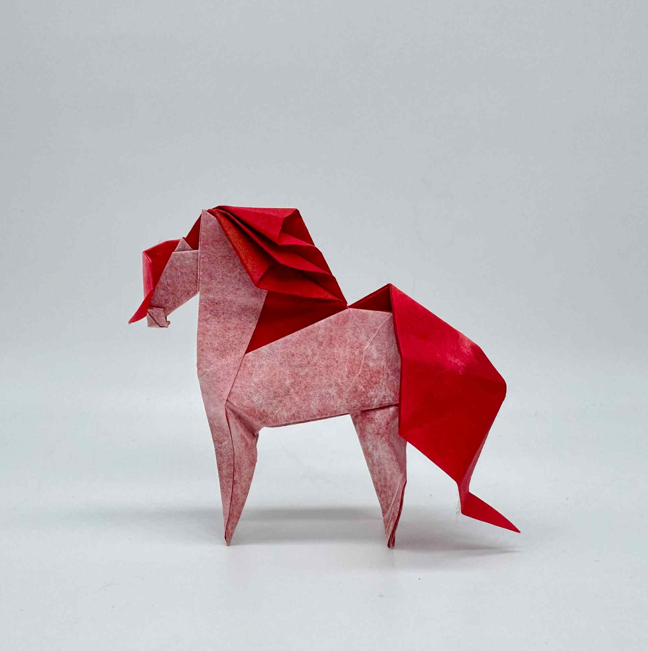 Origami Horse designed by Syn / Jiahui Li, folded by Syn / Jiahui Li, using Luminous Thai paper (#13 WHITE / CORAL RED)